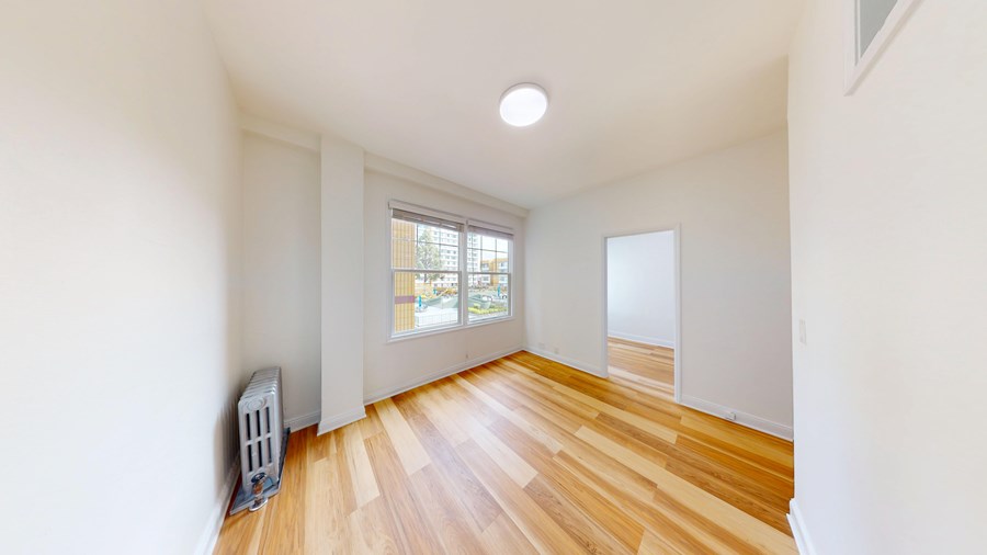 A room with wooden floors and a window.